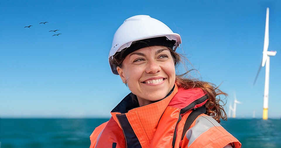 A woman in Personal Protect equipment smiling.