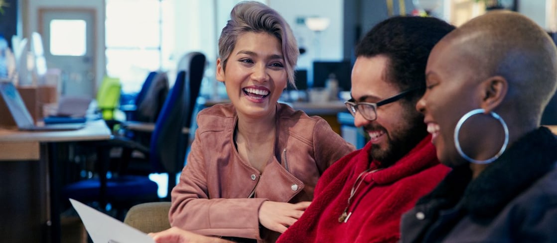 Laughing creative business people working in office