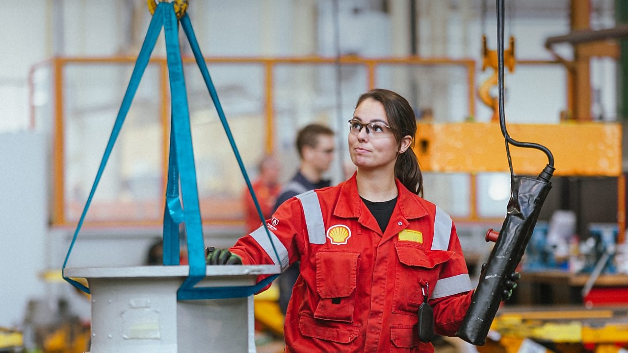A woman employee in a safety uniform working in one of our off shore facilities.