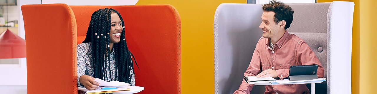 two employees talking in the lounge