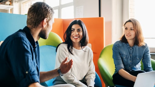 Two employees having a discussion by the window