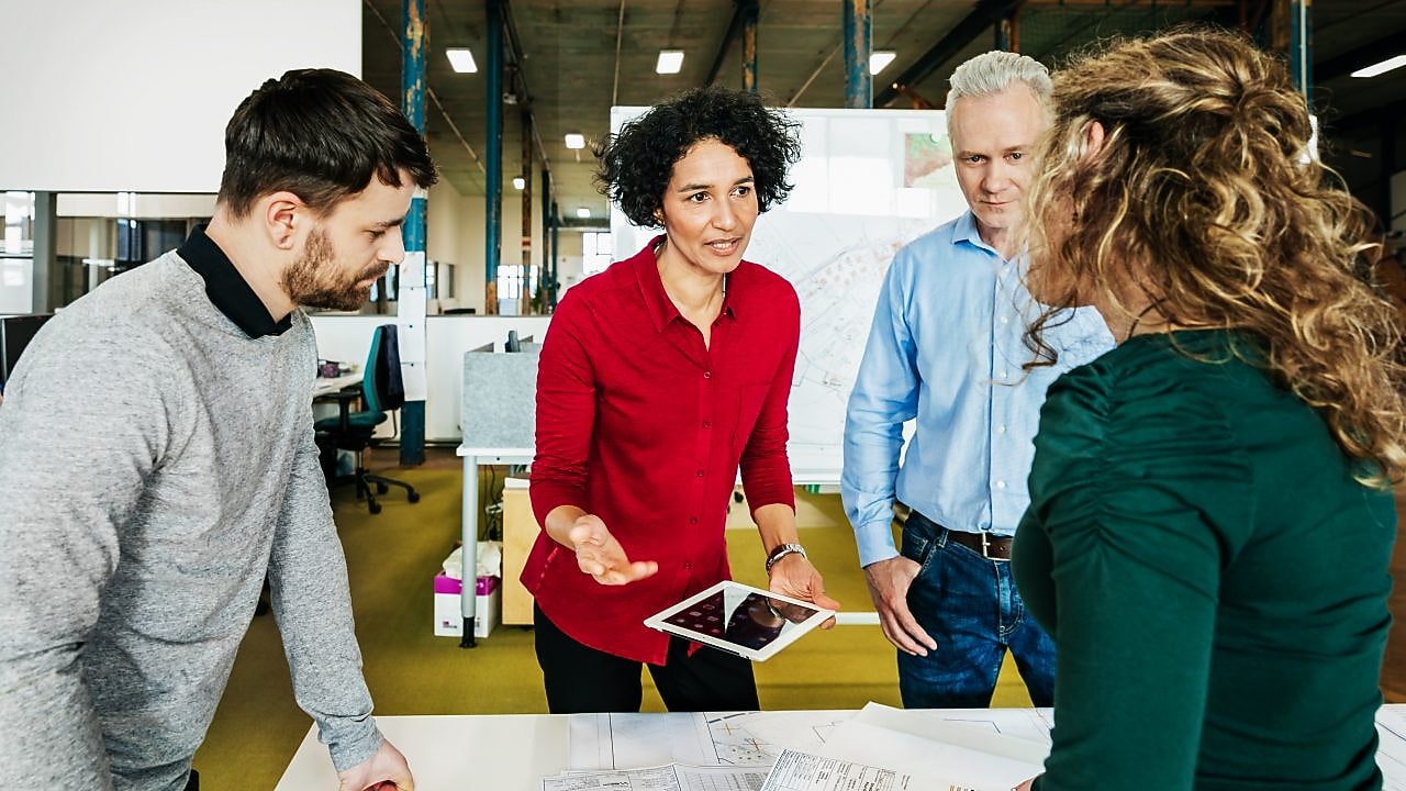 An office manager holding a meeting with her team