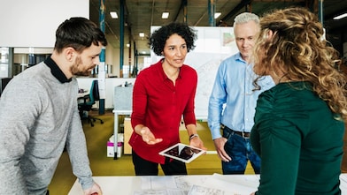 An office manager holding a meeting with her team