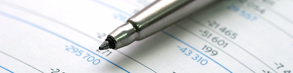 Pen lying on financial documents