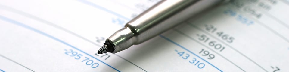 Pen lying on financial documents