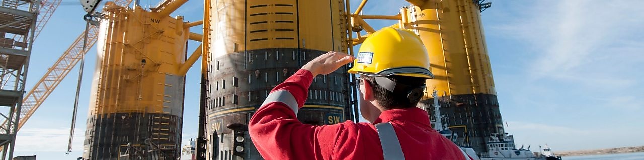 Engineer looking up at platform under construction