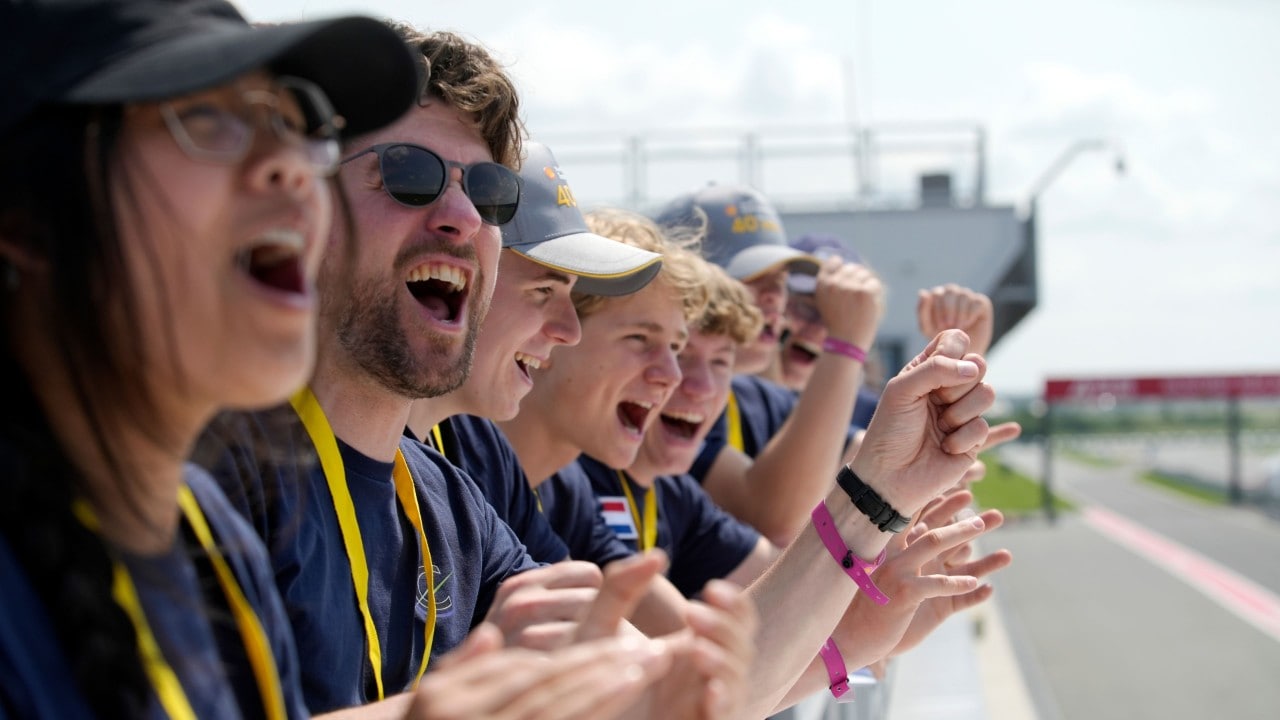 grupa studentów cieszy się i dopinguje