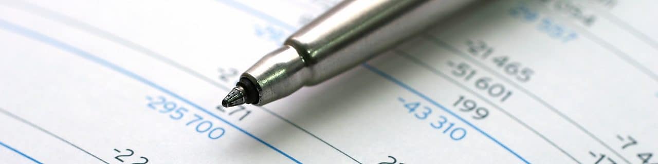 Pen lying on financial documents
