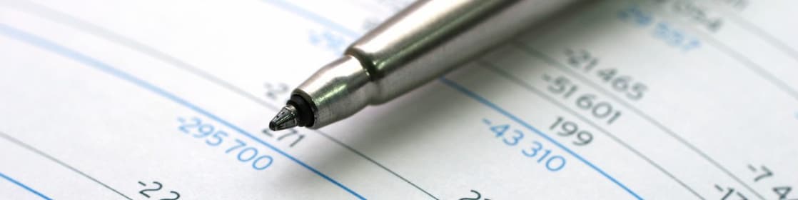 Pen lying on financial documents