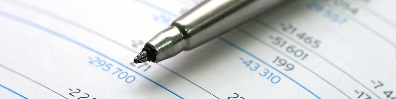 Pen lying on financial documents