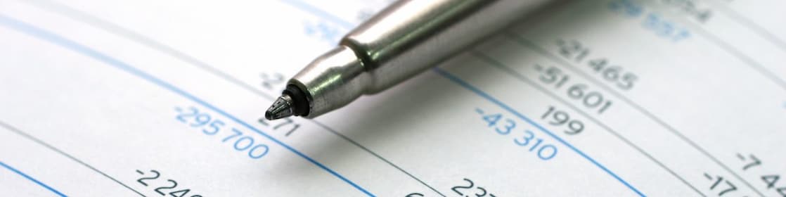 Pen lying on financial documents