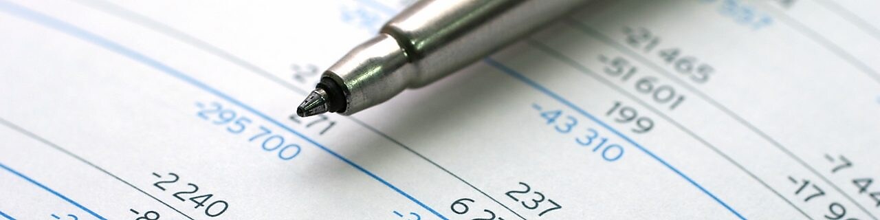 Pen lying on financial documents