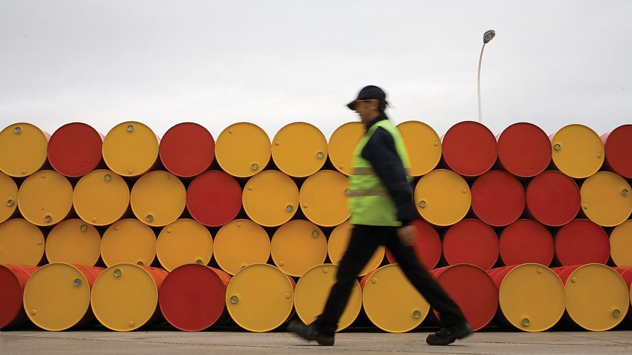 man walking barrels lubricants