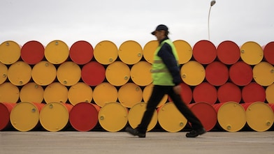 man walking barrels lubricants