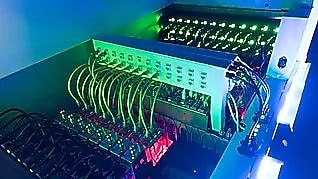 Four business people sitting around a round table reading documents, grey and yellow carpet