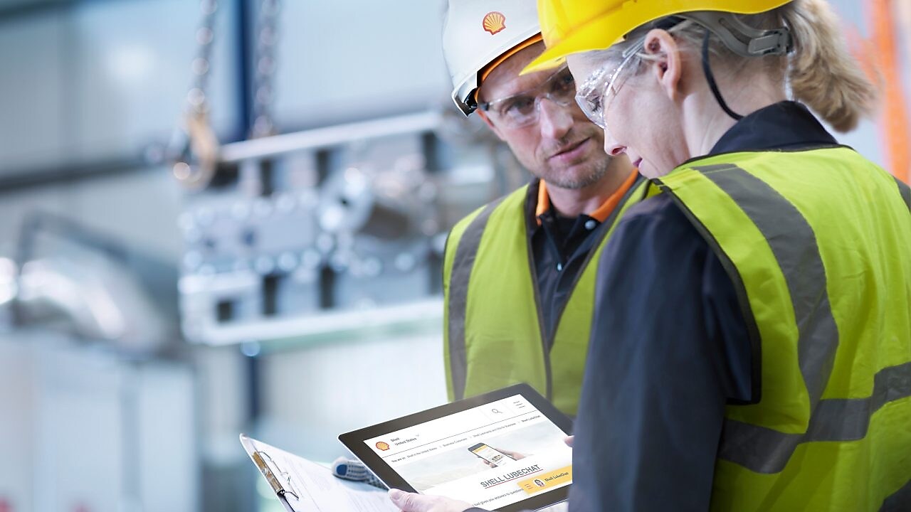 Pracownik Shell udzielający konsultacji pracownikowi przemysłowemu w zakładzie
