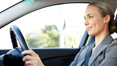 woman driving a car while smiling