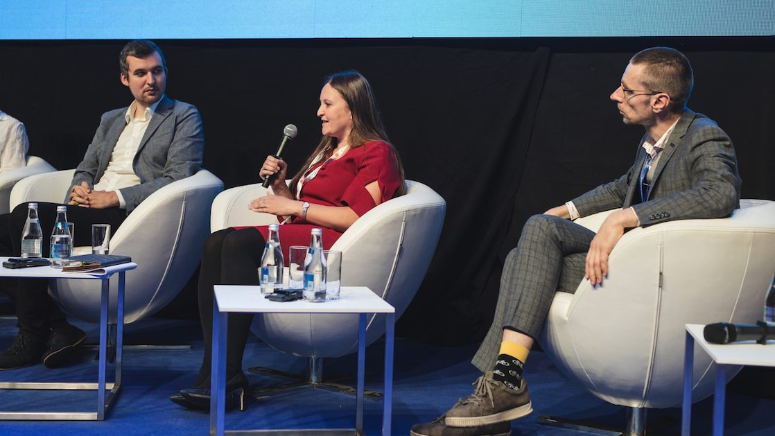 Kobieta w czerwonej sukience trzymająca mikrofon