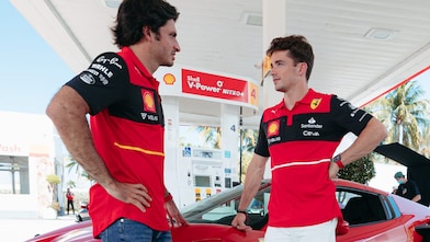 two person talking to each other at a shell station