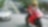 Czerwony motocykl i motocyklista na drodze między samochodami z budynkami w tle