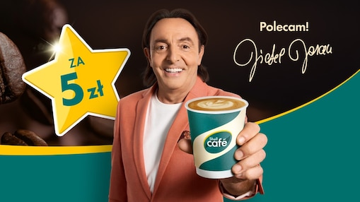 2. Na grafice widoczny jest restaurator Michel Moran z kawą Shell Cafe , obok niego jest duża żółta gwiazda z napisem Kawa za 5 zł, oraz podpis polecam, Michel Moran.